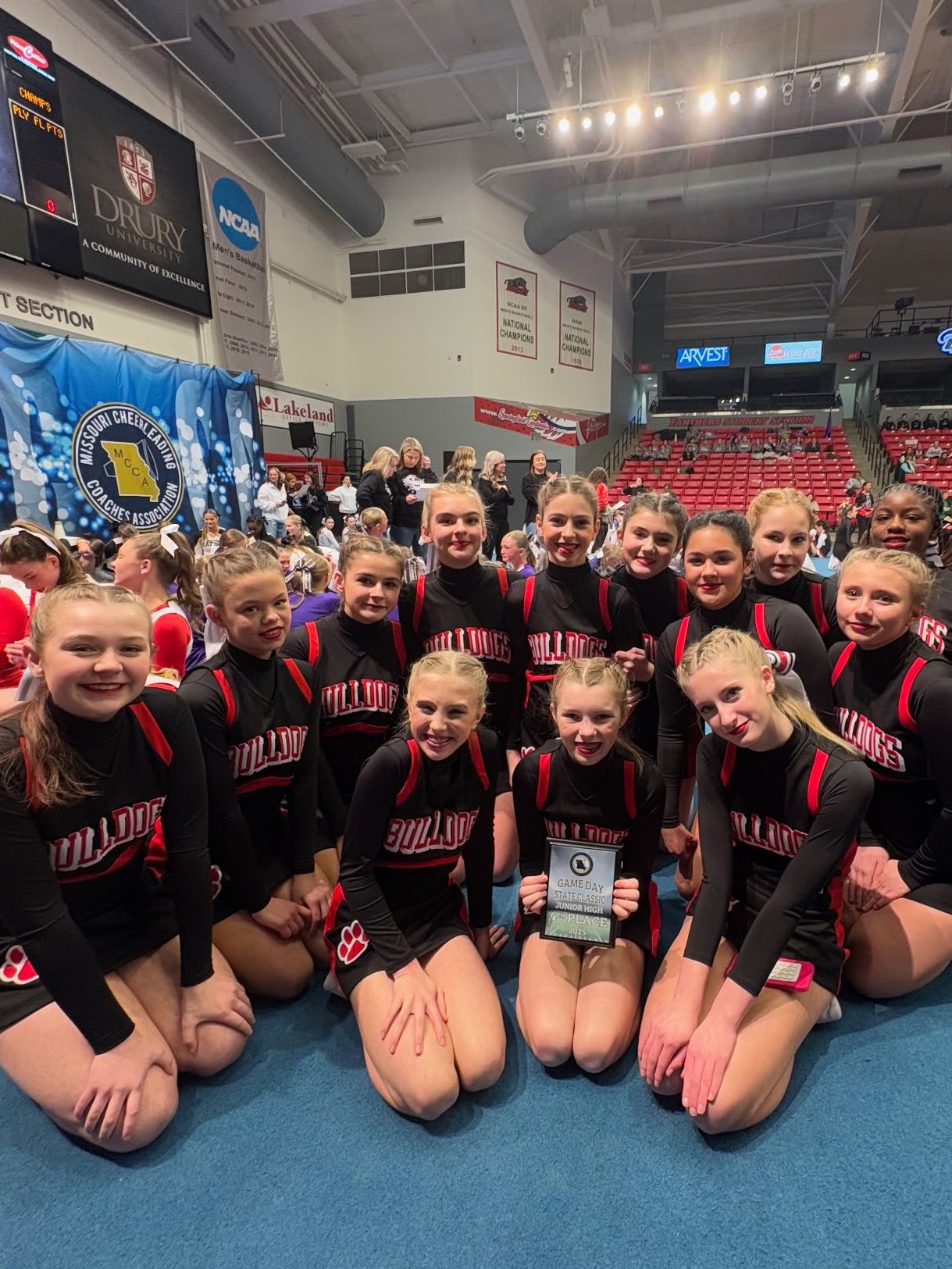 Junior Bulldogs cheerleaders celebrating a competition placement